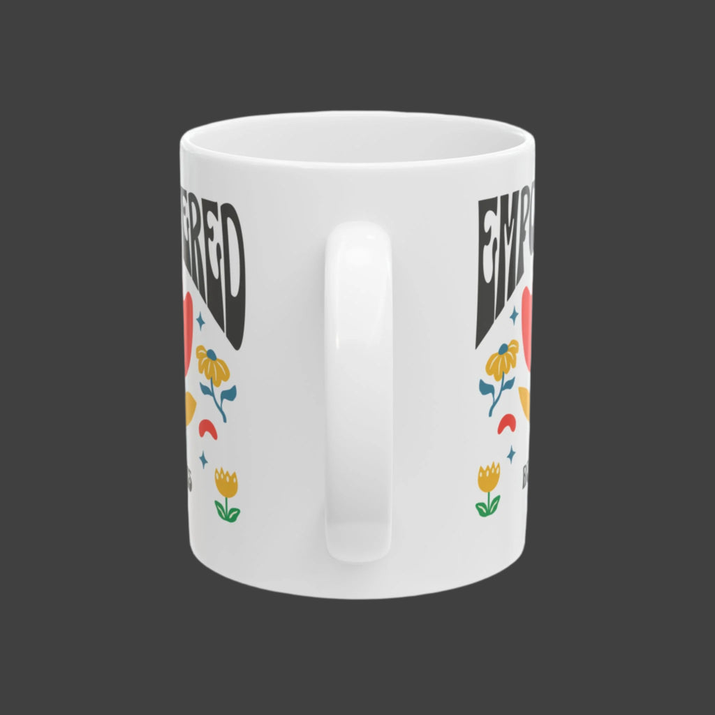 White mug with colorful text and graphics on a white background