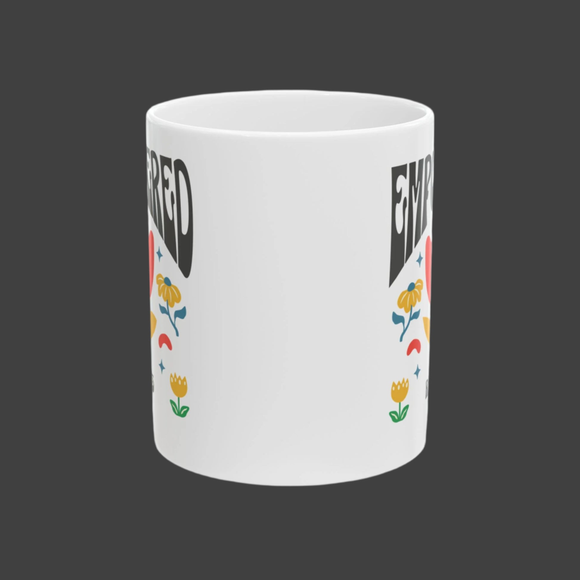 White mug with colorful floral designs and text on a white background