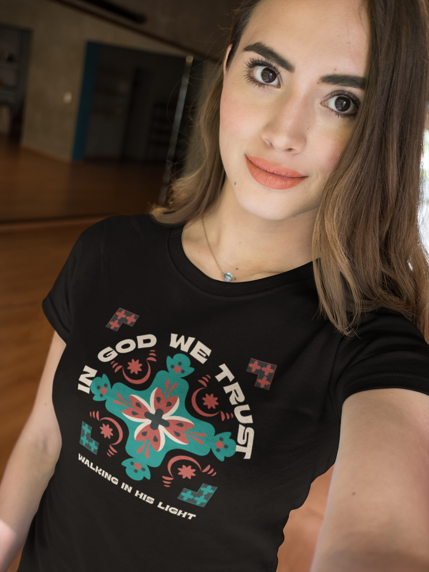 Person wearing a black t-shirt with a colorful design and text.