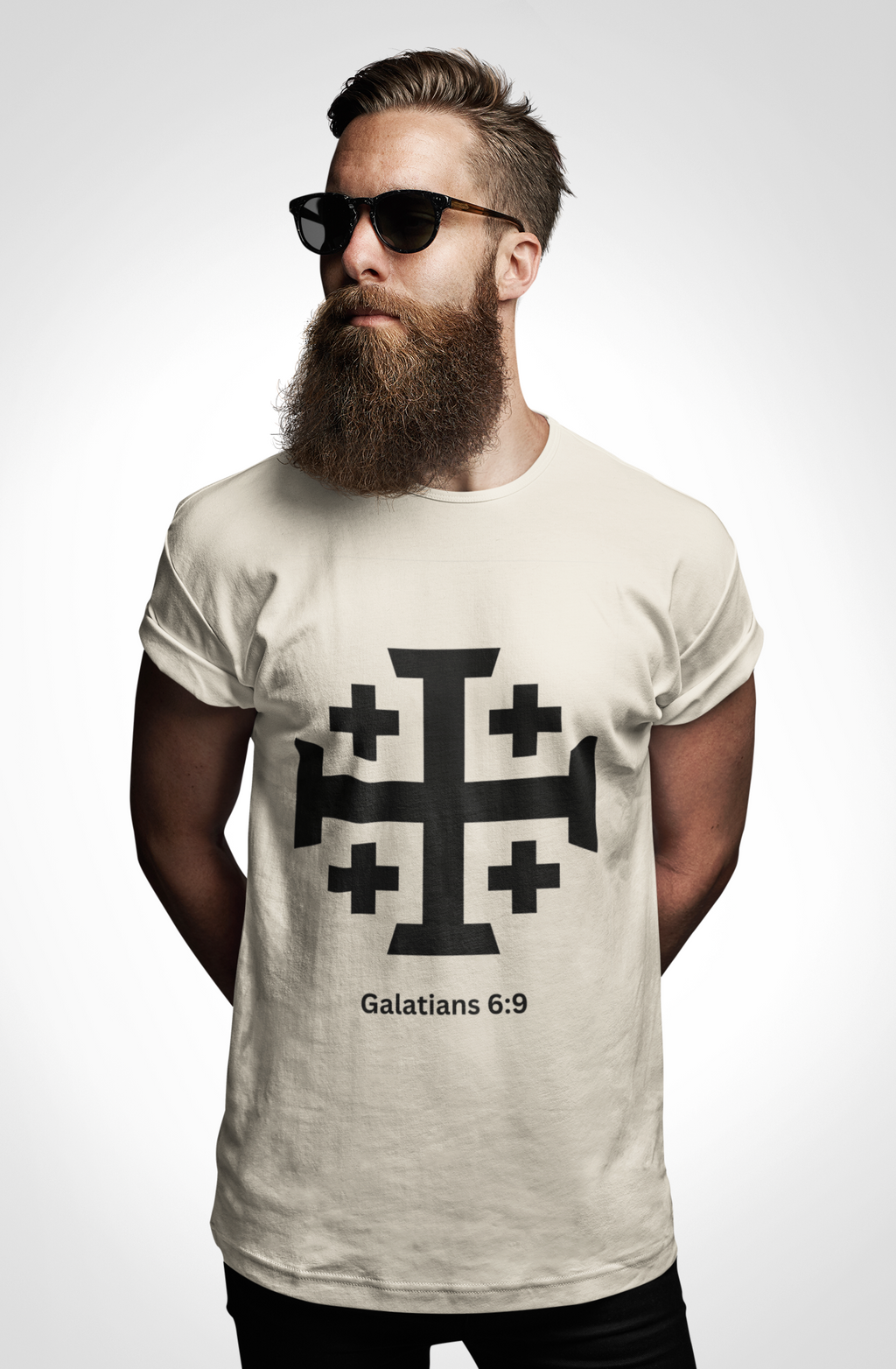 Man wearing a t-shirt with a cross design and text on a plain background