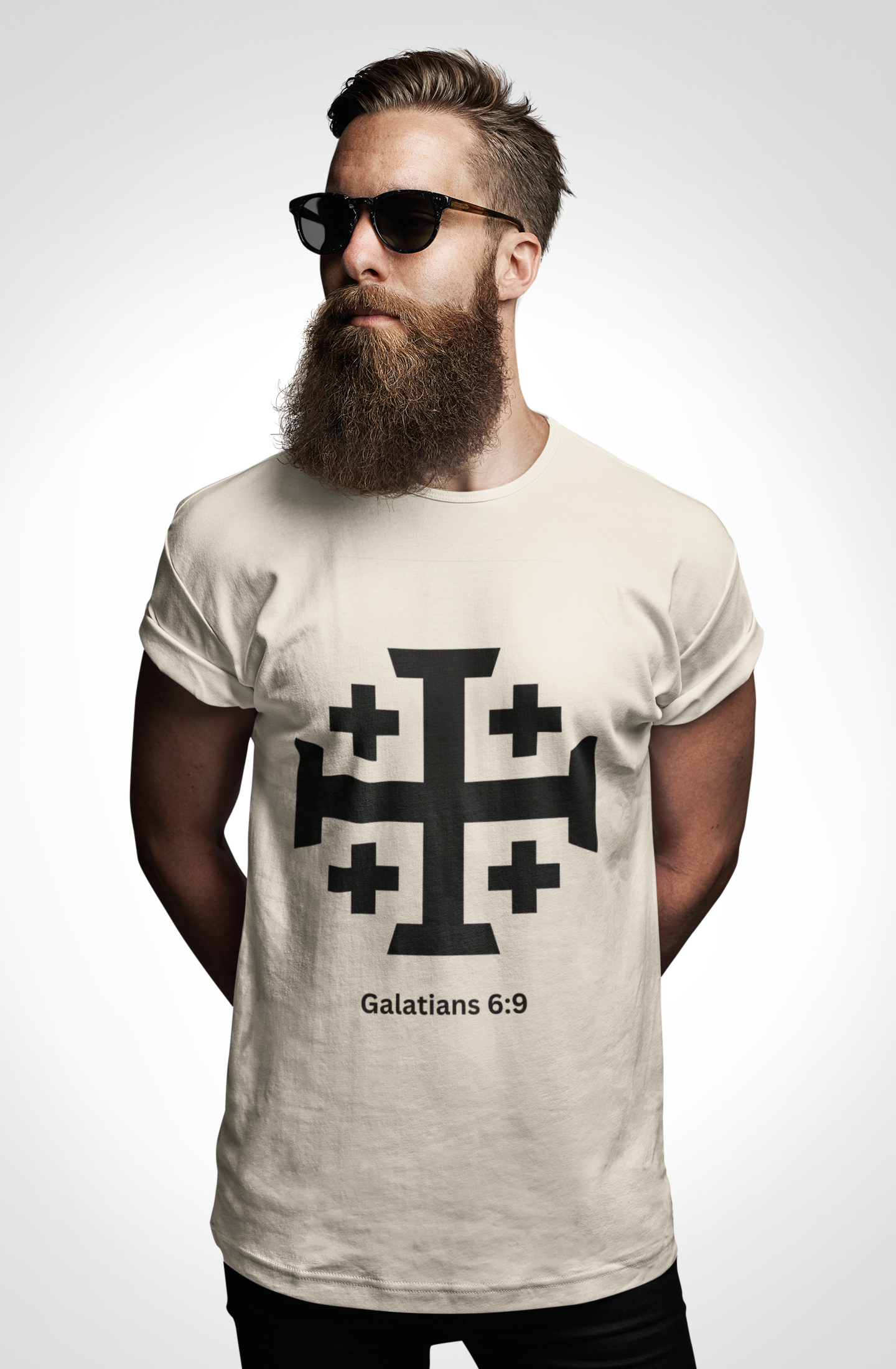 Man wearing a t-shirt with a cross design and text on a plain background