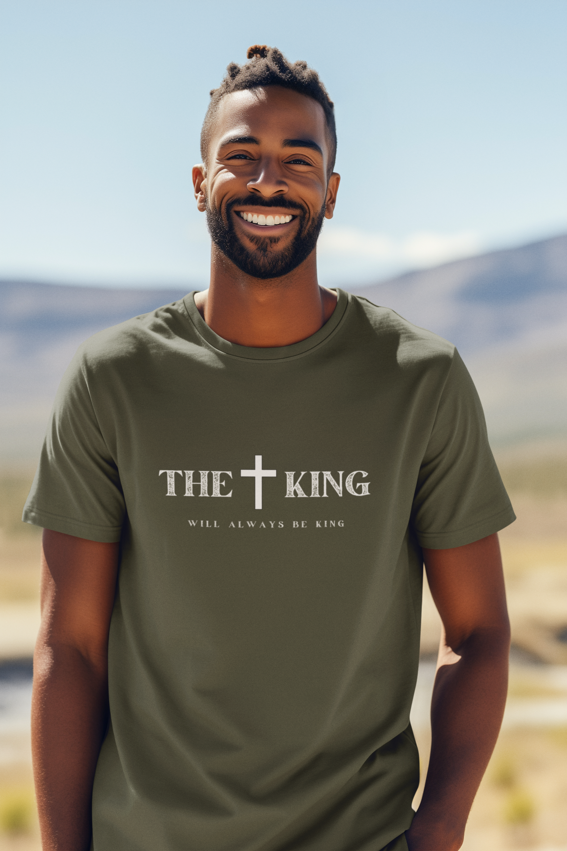 Man wearing a green t-shirt with 'The King Will Always Be King' text outdoors.