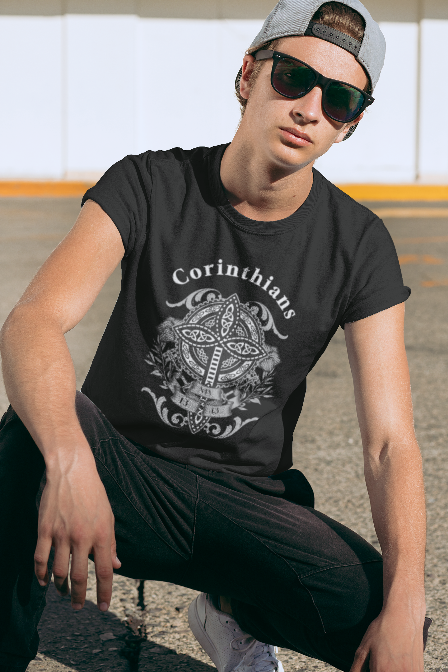 Person wearing a black t-shirt with 'Corinthians' design outdoors.