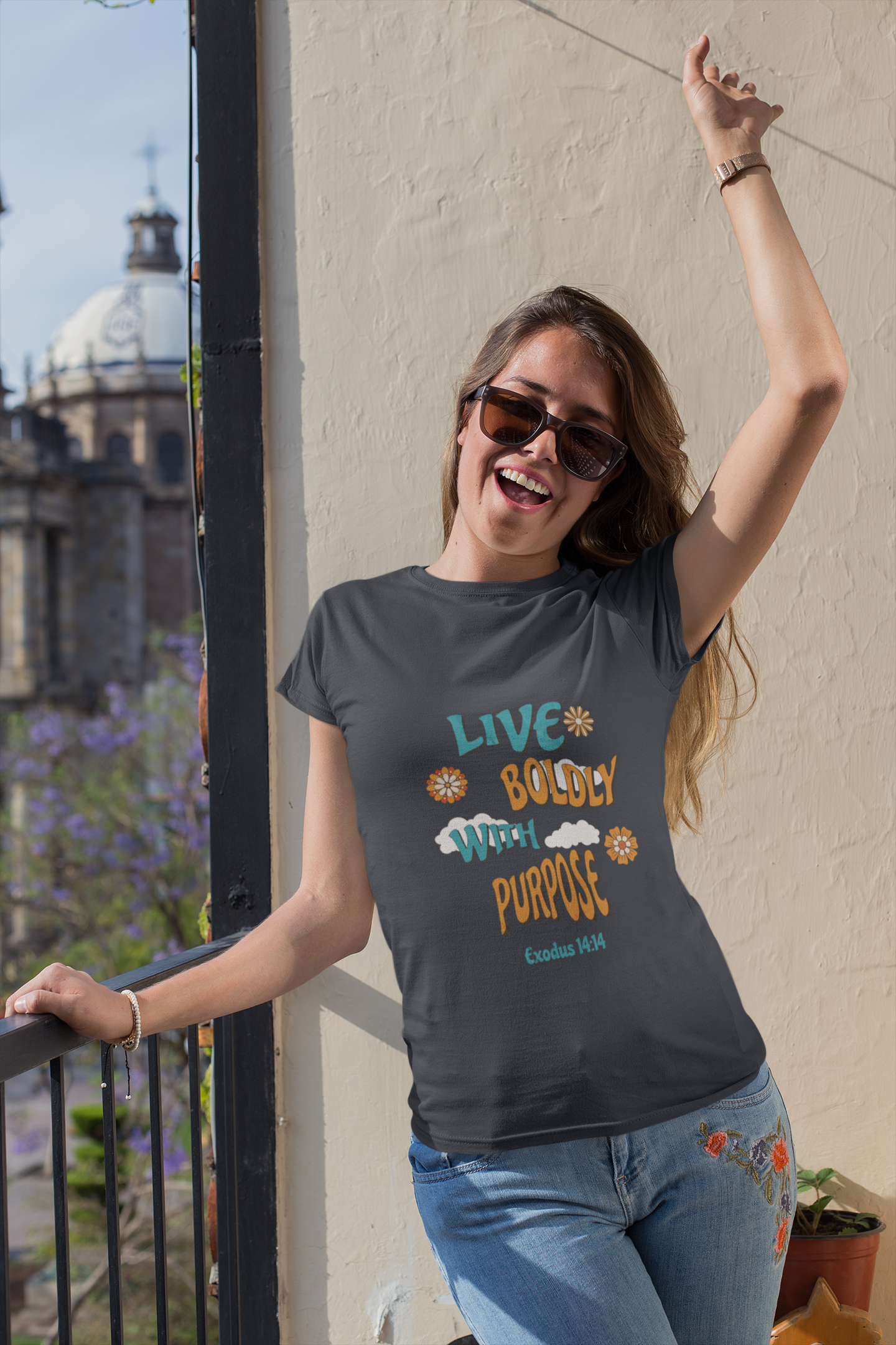 Woman wearing a t-shirt with motivational text, standing outdoors.